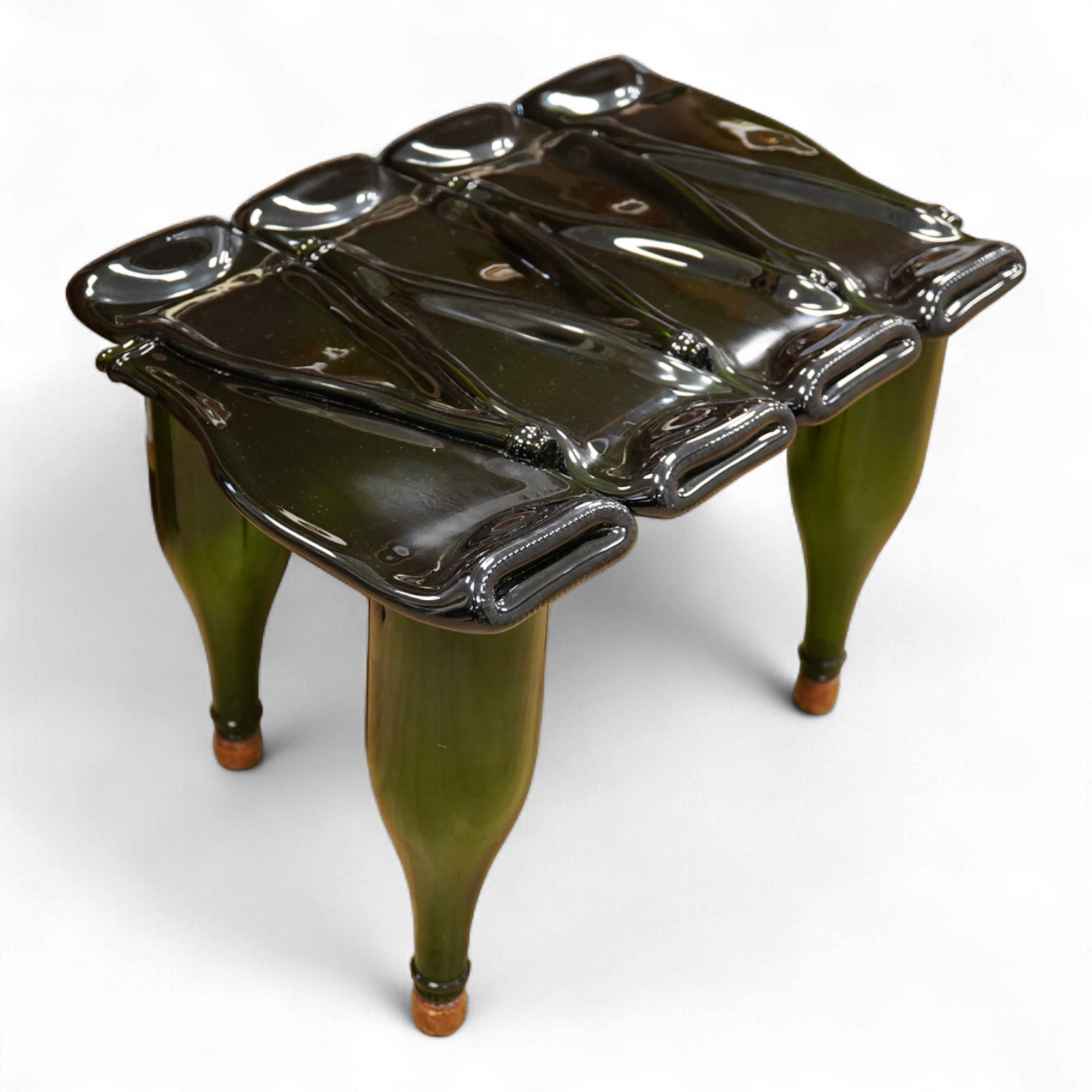 A Mary Canny ‘Champagne’ green art glass bottle table, 34cm high x 55cm wide x 38cm deep